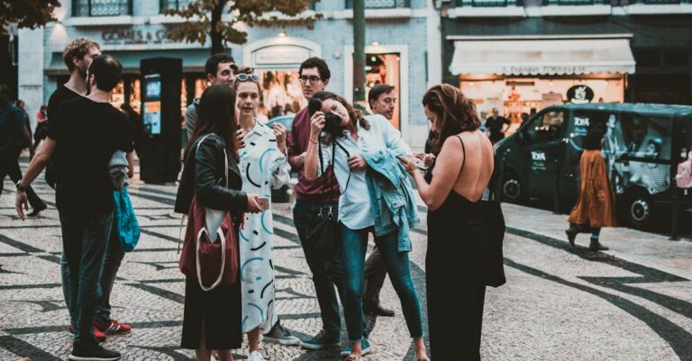 Casual group of tourists socializing and taking photos on a bustling European street.