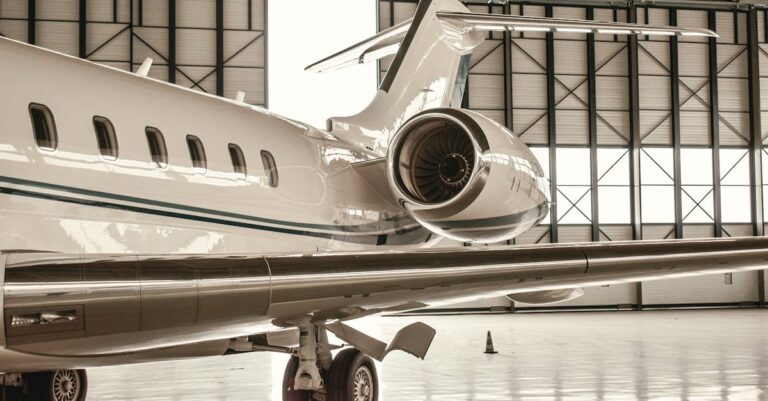 A sleek private jet parked inside a modern hangar in Paris, France.