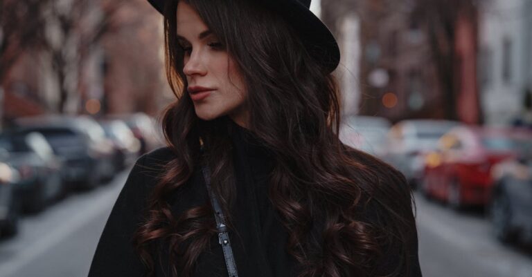 Portrait of a fashionable woman in a black hat on a city street in New York.