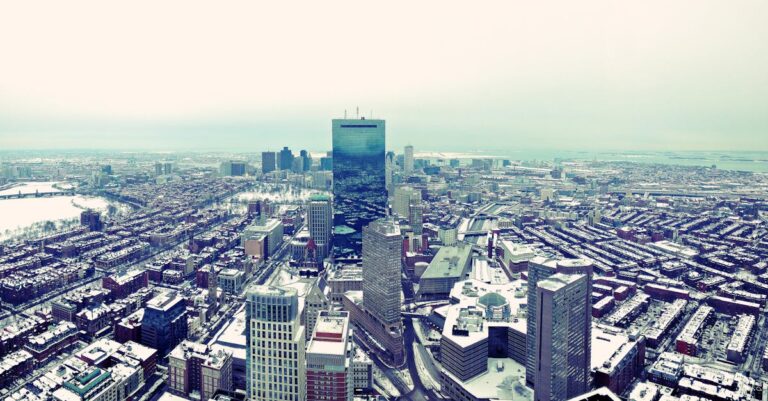 Aerial view of Boston's snow-covered cityscape and skyline on a winter day.