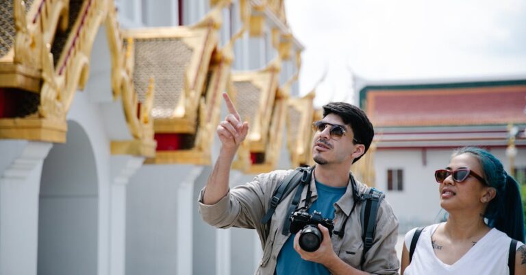 A couple of tourists admire intricate architecture, capturing moments with a Canon camera.