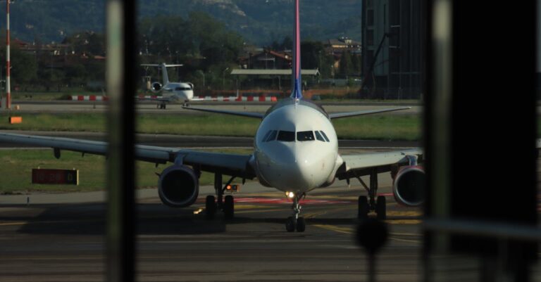 Front view of airplane on runway in Lombardia, Italy, ready for departure.