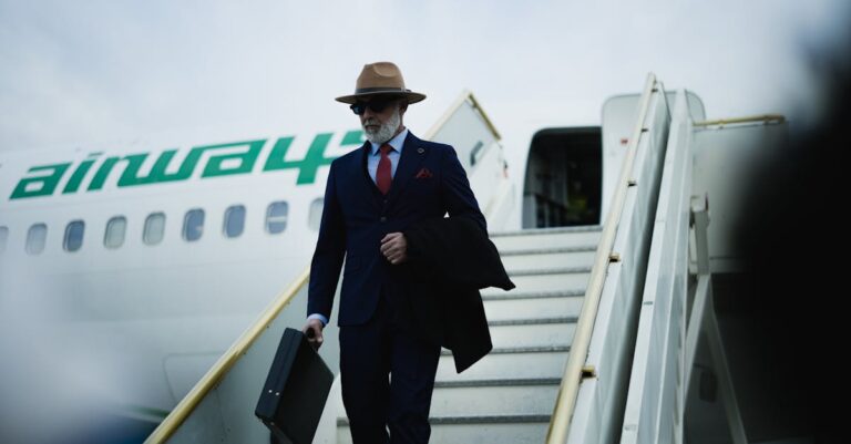 A stylish businessman with briefcase steps onto tarmac, exuding confidence and elegance.