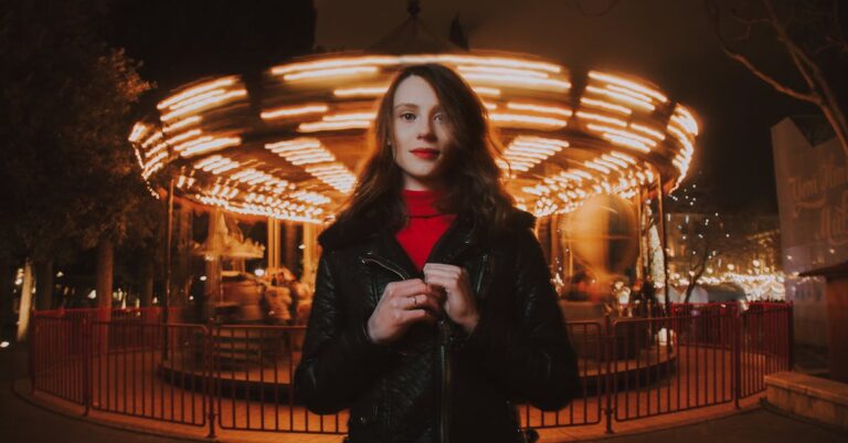 Portrait of a woman at night in front of an illuminated carousel in Baku, Azerbaijan.