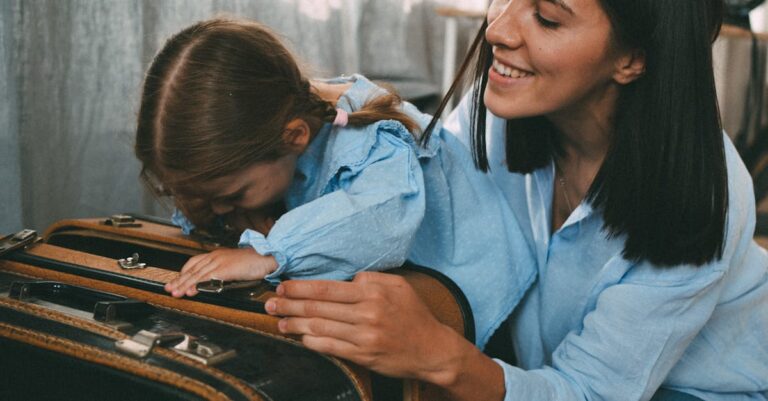 A mother and daughter joyfully pack a suitcase for a family trip, sharing a warm moment.