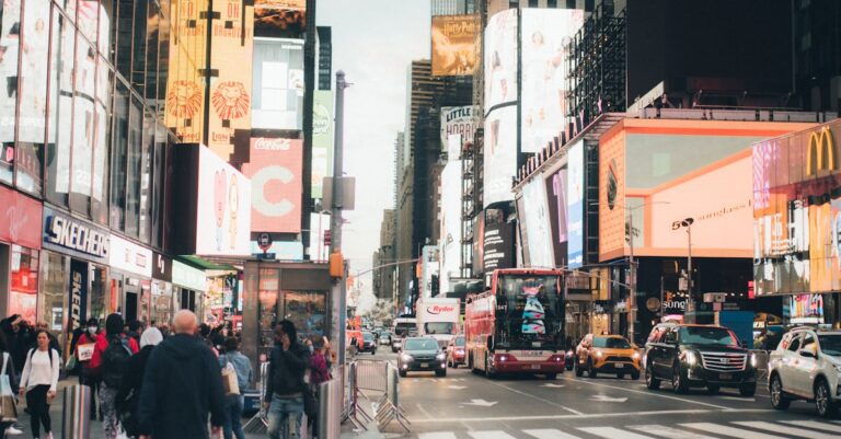 Busy Times Square in NYC, bustling with people, billboards, and traffic.