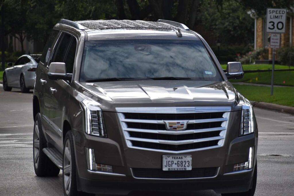 Sleek Black Suv From A Luxury Car Service In Newark Parked Outside Newark Liberty International Airport, Offering Premium Travel In 2025.