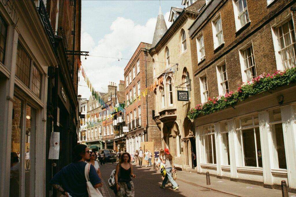 Vibrant street scene with people and historic buildings in Cambridge, England.