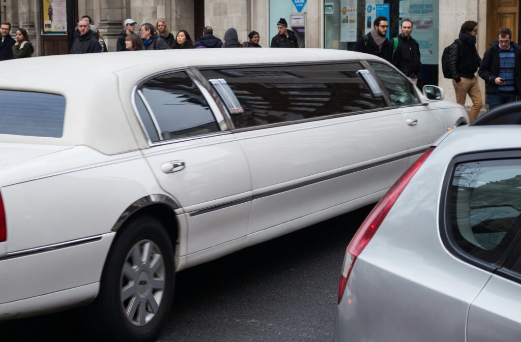 All Limo Options for NYC Families: 7 Honest Facts for 2027 2 September 20, 2026 A white limousine driving down a bustling city street with pedestrians and other vehicles.