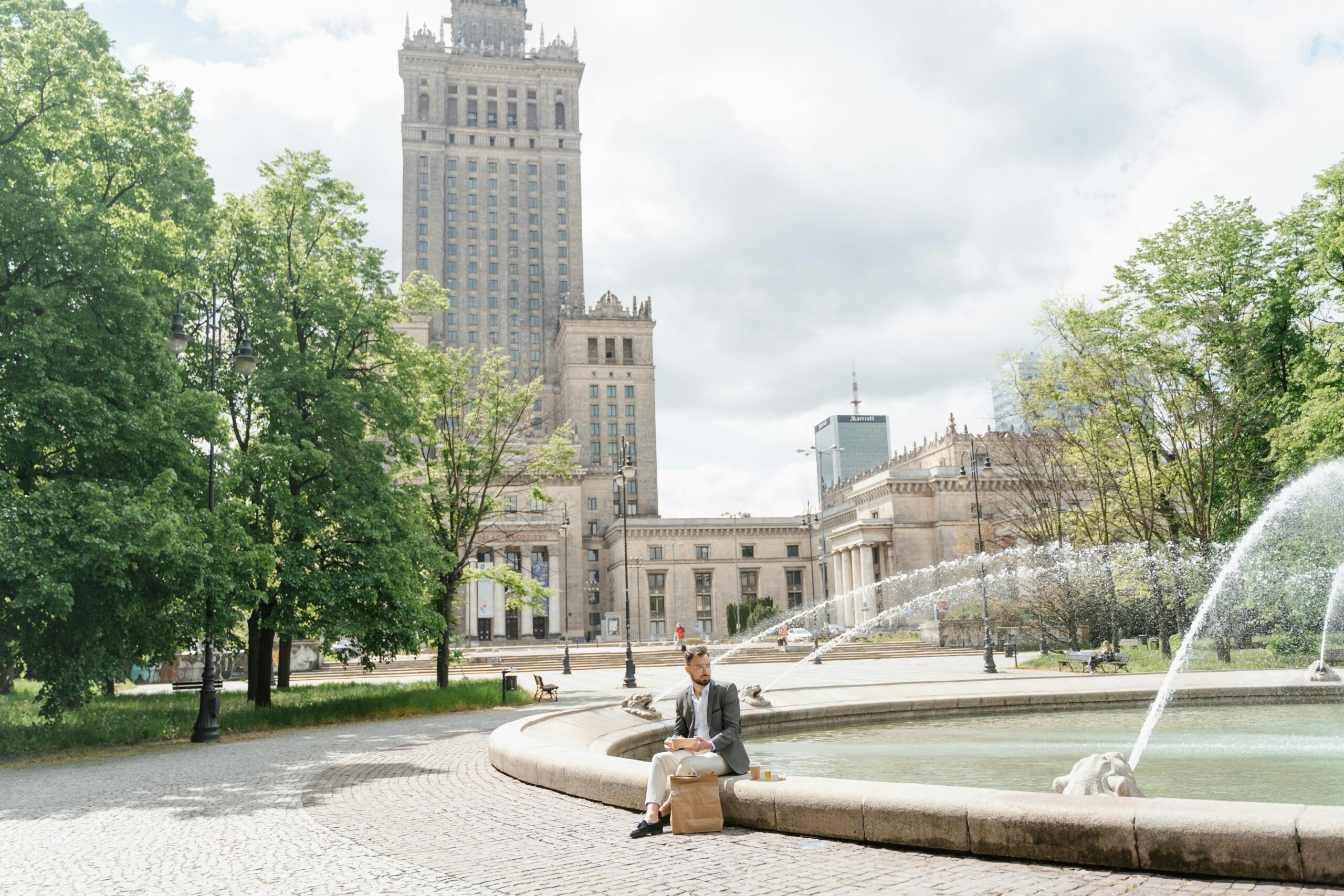 Blogs | Articles | News | Tips & Tricks | Video | FAQ | Infomation 14 September 20, 2026 A man sits by a fountain near the Palace of Culture and Science in Warsaw, enjoying a casual lunch outdoors.