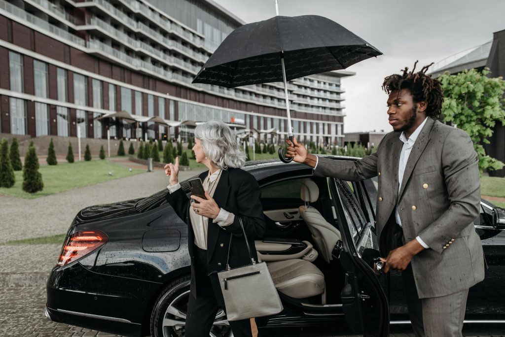 new york limousine service JetBlack black sedan at JFK airport pickup zone