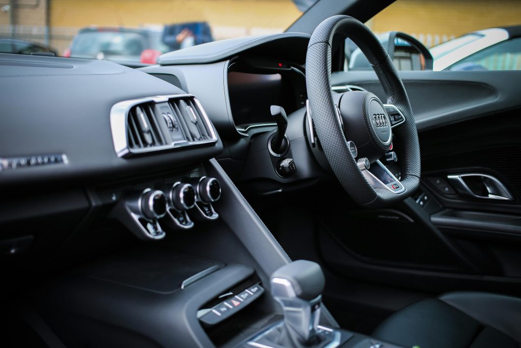nyc chauffeur service for airport transfers black sedan at JFK pickup zone