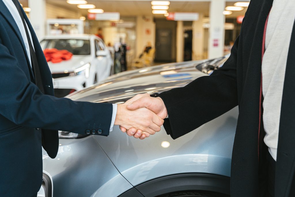 nyc chauffeur service for airport transfers black sedan at JFK pickup zone