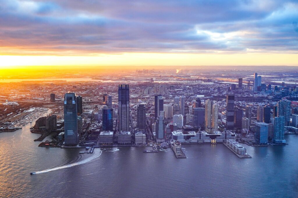 Limo Services in New Jersey Prices: Honest 2026 Corporate Comparison 4 September 19, 2026 Breathtaking aerial view of Jersey City's modern skyline at sunset with vibrant colors and skyscrapers.