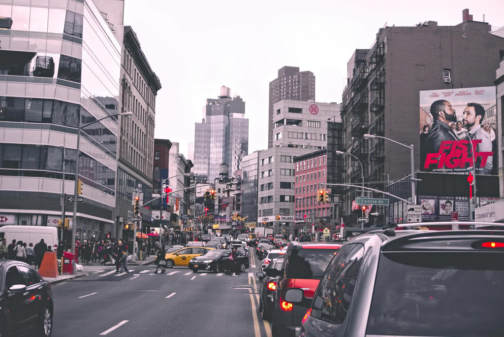 NYC Cars for Families: 7 Honest Seasonal Tips 2027 4 October 9, 2026 Lively city street in New York with bustling traffic and urban buildings during the day.