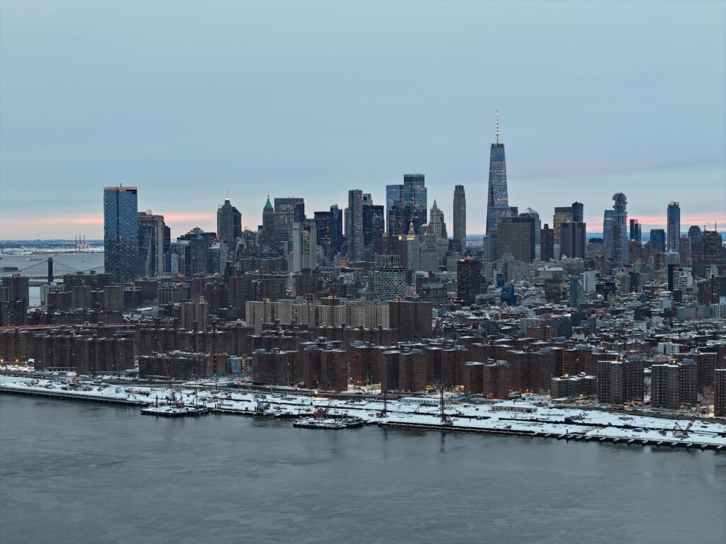Manhattan Airport NYC: 5 Honest Options for Families with Luggage 2026 5 September 27, 2026 A stunning aerial shot of New York City skyline covered in snow during the day.