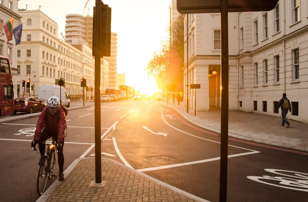 morning, golden sun, yellow, sun, city, urban, waking up, sunrise, sunlight, light, bright, traffic, van, bus stop, transport, asphalt, light background, cars, driving, pedestrian, buildings, nature, road, street, travel, bicycle, helmet, man, brown car, brown city, brown sun, brown road, brown sunrise, brown street, brown bus, brown morning, brown stop