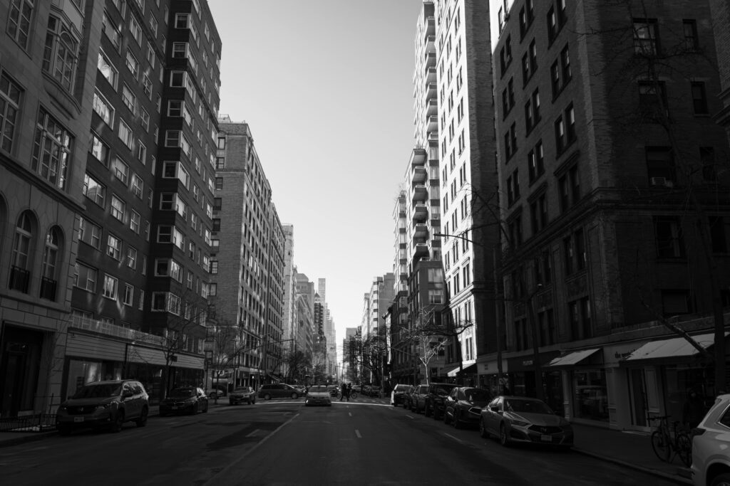 Service Car NYC for Families: 5 Honest Seasonal Facts for 2026 9 September 24, 2026 Urban cityscape in black and white capturing a quiet New York City street.