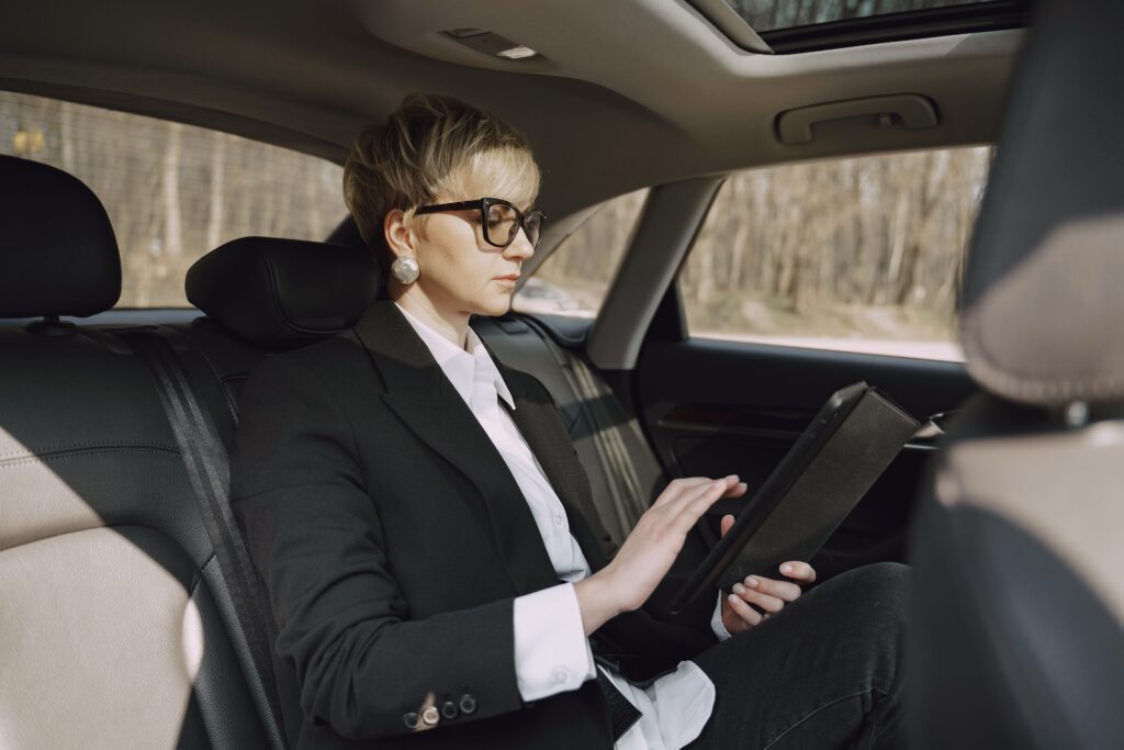 US Limousine Service NYC: 7 Honest Facts for 2027 8 September 18, 2026 Side view of focused female in stylish formal clothes using tablet while riding on backseat of modern car