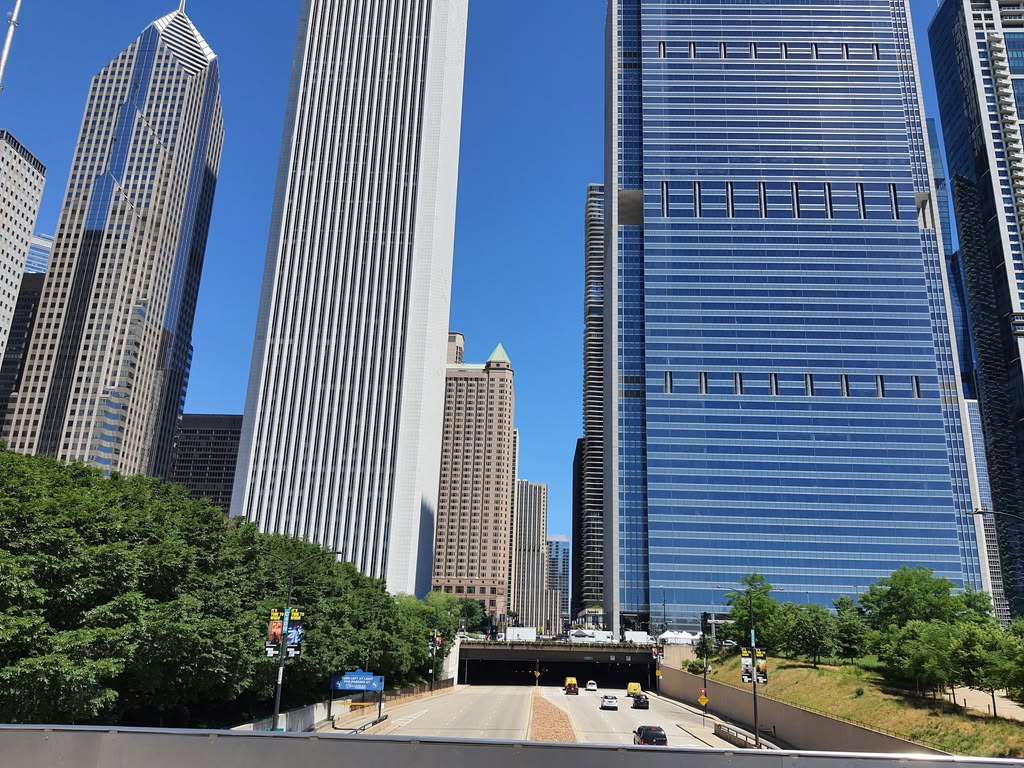 View of Chicago's iconic skyscrapers with a clear blue sky and urban landscape.