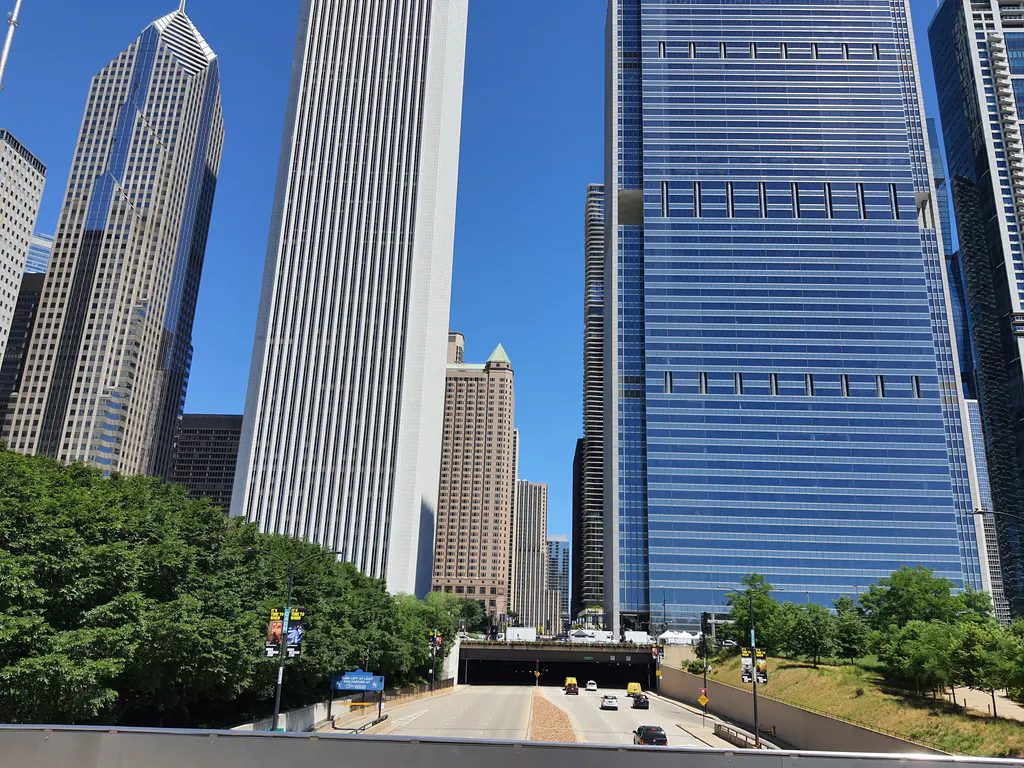 View of Chicago's iconic skyscrapers with a clear blue sky and urban landscape.